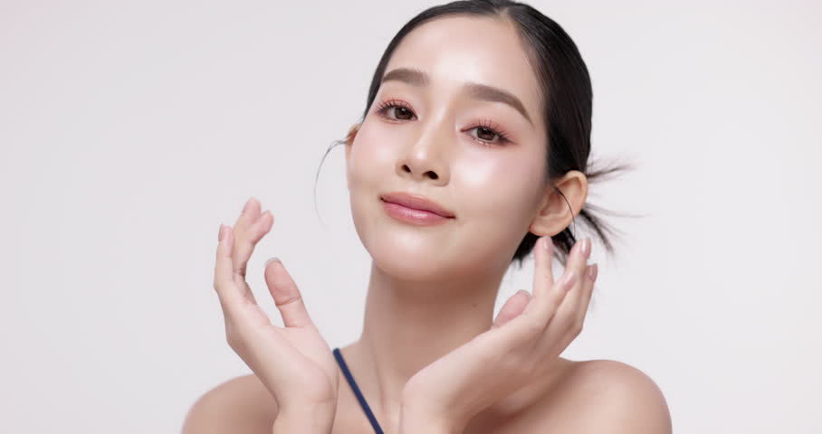 Slow motion of beautiful young Asian girl with k-beauty make up style on isolated white background for commercial beauty advertising.