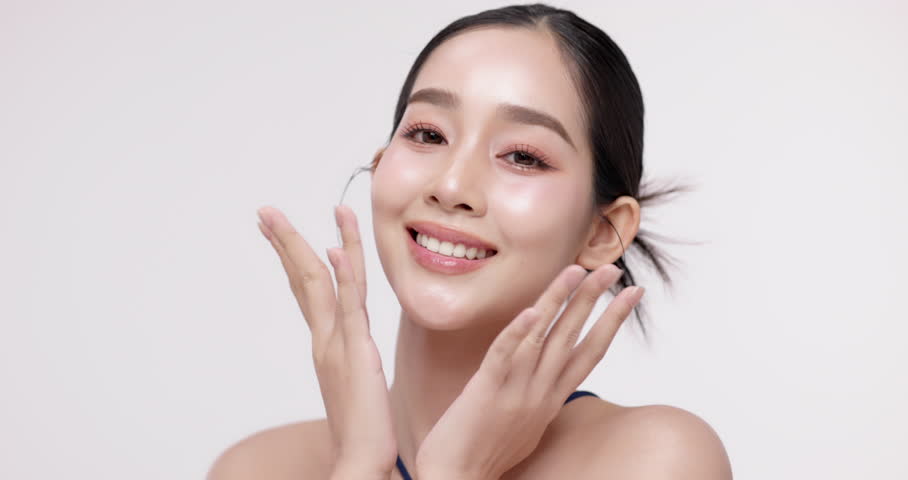 Slow motion of beautiful young Asian girl with k-beauty make up style on isolated white background for commercial beauty advertising.