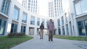 Young women dancing outside modern building - Powered by Shutterstock - Get 15% off with code: PIKWIZARD15
