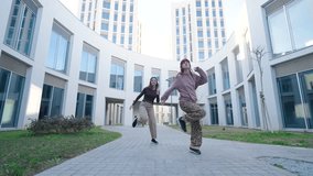 Young women dancing outside modern building - Powered by Shutterstock - Get 15% off with code: PIKWIZARD15