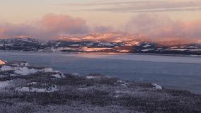 Snow-covered Forest And Mountain With Frozen Lake Laberge During Winter In Yukon, Canada. - aerial shot - Powered by Shutterstock - Get 15% off with code: PIKWIZARD15