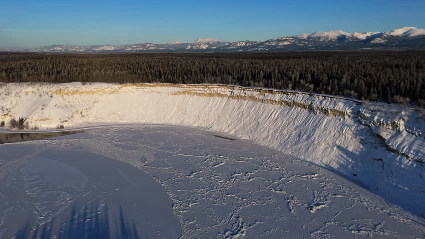 Aerial View Of Frozen Lake Laberge During Winter In Whitehorse, Yukon, Canada - Drone Shot
