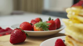 Drizzling honey on freshly made pancakes with strawberry and blueberry - Powered by Shutterstock - Get 15% off with code: PIKWIZARD15