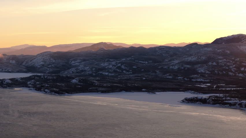 Aerial View Of Frozen Lake Laberge At Sunrise In Whitehorse, Yukon in Canada.