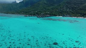 Sofitel Kia Ora Resort Moorea Toatea Lookout French Polynesia aerial drone snorkel swim turquoise bungalow blue water coral reef blue sky cloud layer mtns Tema'e Public Beach Beach forward pan up - Powered by Shutterstock - Get 15% off with code: PIKWIZARD15