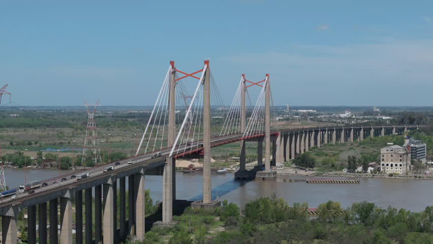 Aerial view of cable-stayed road and railway bridge over Paraná River. Buenos Aires Province, Argentina. 4k.