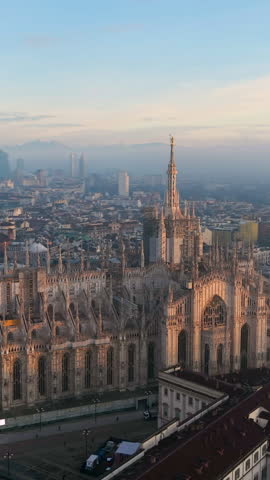 Aerial vertical view of the central spire of the duomo and the city