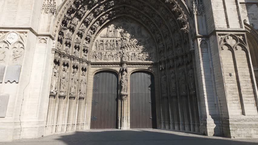 Gothic Cathedral of Our Lady entrance with detailed stone carvings and large double doors in Antwerp