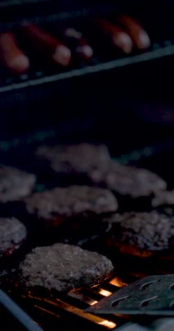 Vertical Format of Delicious BBQ Grill with Hamburgers and Hot Dogs.
