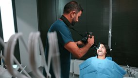 Dentist photographing a female patient’s teeth after treatment. Clean white teeth appear on the camera screen, capturing a bright transformation and a confident, healthy smile.
 - Powered by Shutterstock - Get 15% off with code: PIKWIZARD15