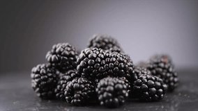 Blackberry closeup, blackberries background. Fresh Ripe organic black berries rotating over gray backdrop, close-up. Macro shot. Market. Vegan food.  - Powered by Shutterstock - Get 15% off with code: PIKWIZARD15