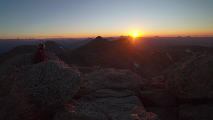 Person at Mount Blue Sky Evans last sunlight sunset sundown on horizon top Bierstadt Grays Torreys peak front range fourteener Rocky Mountains Colorado Grays Torreys Idaho Springs Evergreen pan right