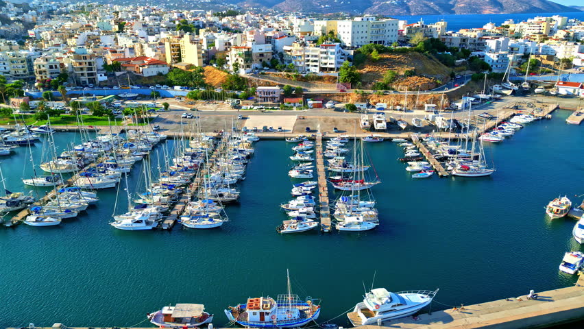 Agios Nikolaos port marina Crete island Greece aerial drone boats moored, aerial drone view