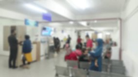 An intentionally blurred image showing a diverse crowd in a waiting room setting. The soft focus creates a sense of anonymity, underscoring the universal experience of seeking medical assistance. - Powered by Shutterstock - Get 15% off with code: PIKWIZARD15
