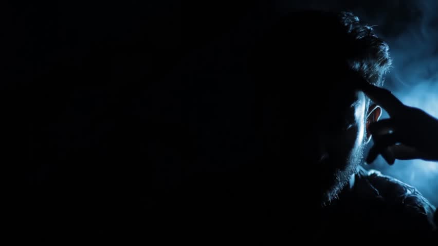 Cinematic Shot of a Hitman Sitting at a Table Holding a Gun with Dramatic Lighting — Intense and Mysterious Scene