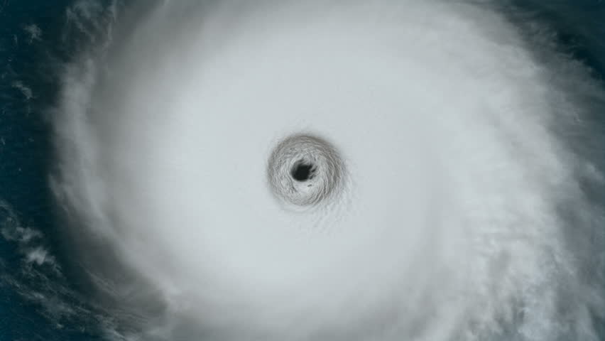 Hurricane: A large ominous spinning hurricane as we fly out from the eye and see