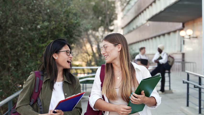 Happy College student girl friends talking and walking to University School. Diverse Asian and American Youth - Powered by Shutterstock - Get 15% off with code: PIKWIZARD15
