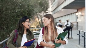 Happy College student girl friends talking and walking to University School. Diverse Asian and American Youth - Powered by Shutterstock - Get 15% off with code: PIKWIZARD15