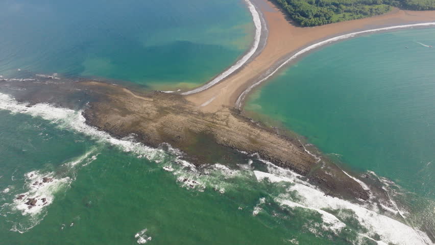 This aerial photograph captures Punta Uvita in Marino Ballena National Park, showcasing its breathtaking coastline and crystalclear turquoise waters