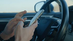 Close-up of driver hands using smartphone while driving car, risk of distraction and road safety concerns. Dangerous driving of vehicle, violation of traffic rules - Powered by Shutterstock - Get 15% off with code: PIKWIZARD15