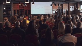 Business seminar with diverse audience focusing on a presenter in conference room - Powered by Shutterstock - Get 15% off with code: PIKWIZARD15