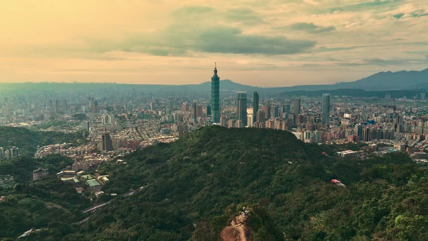 Slow motion video, high angle, Taiwan Taipei101  mountains in front yellow sky, drone view city 