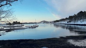Snow covered winter landscape of Norwegian fjord traditional red houses of countryside rural residences - Powered by Shutterstock - Get 15% off with code: PIKWIZARD15