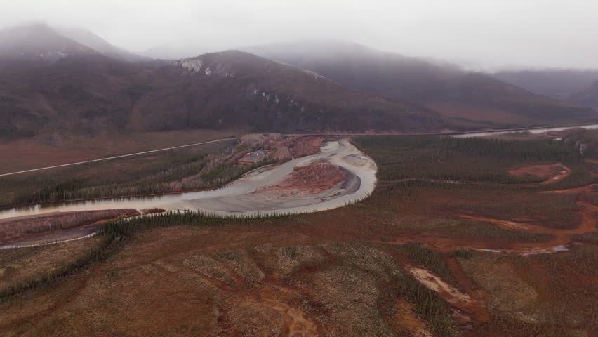 Meandering River Through Autumn Landscape Of Ogilvie Mountains In Yukon, Canada. aerial shot