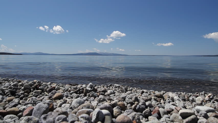 Yellowstone Lake recorded from the shore line in Yellowstone Park, Wyoming, during the summer. View from rocky shoreline.