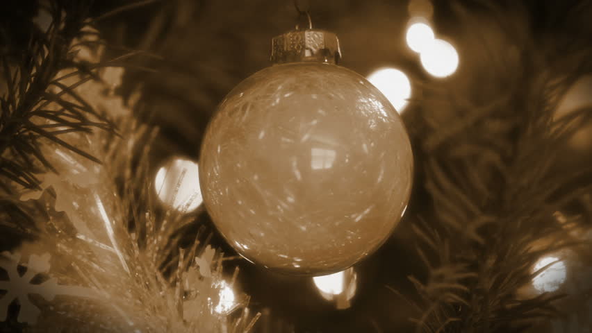 Dolly shot of decorations on a Christmas Tree, coming to rest on a silver