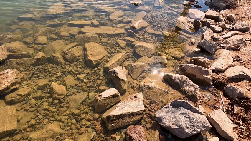 footage of a gorgeous landscape at Papago Park with a lake, lush green palm trees and rocks in Phoenix Arizona USA