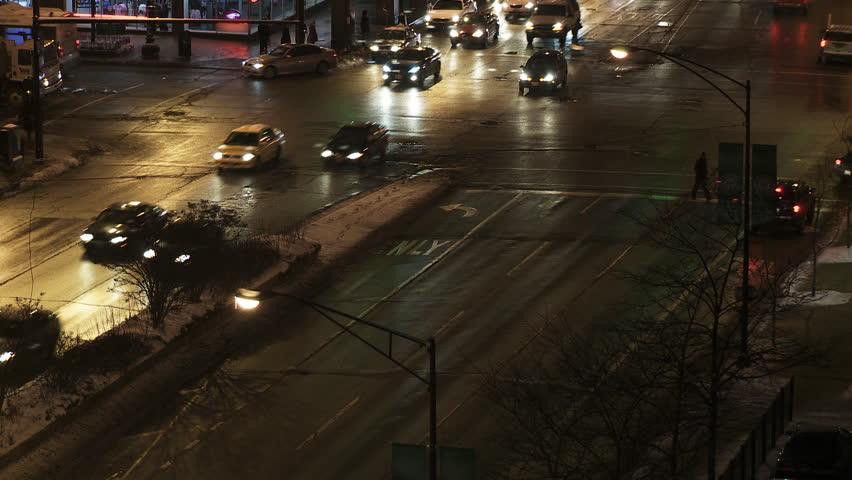 City traffic intersection in Chicago in winter, with pedestrians, cars and other