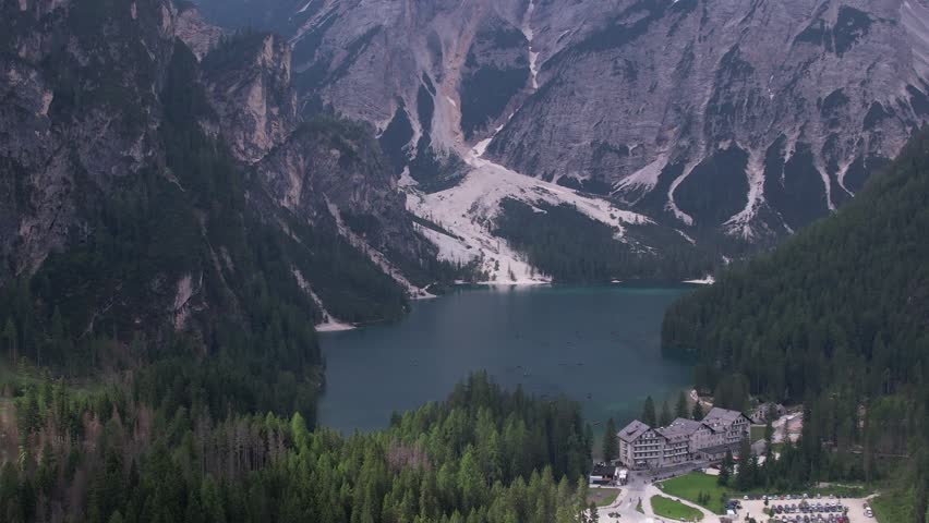 DRONE AERIAL FOOTAGE: View of Braies Lake (Pragser Wildsee), a blue mountain lake on Fanes-Senes-Braies with Croda del Becco mountain in the background, Dolomites, Trentino, South Tyrol, Italy.