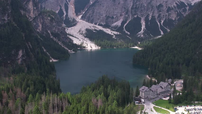 DRONE AERIAL FOOTAGE: View of Braies Lake (Pragser Wildsee), a blue mountain lake on Fanes-Senes-Braies with Croda del Becco mountain in the background, Dolomites, Trentino, South Tyrol, Italy.