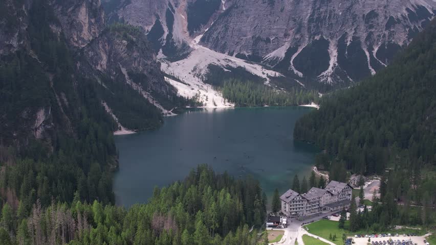 DRONE AERIAL FOOTAGE: View of Braies Lake (Pragser Wildsee), a blue mountain lake on Fanes-Senes-Braies with Croda del Becco mountain in the background, Dolomites, Trentino, South Tyrol, Italy.