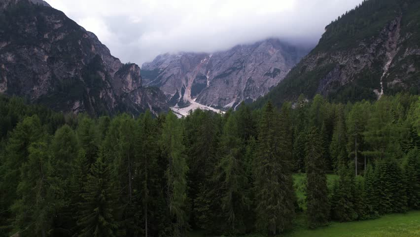 DRONE AERIAL FOOTAGE: View of Braies Lake (Pragser Wildsee), a blue mountain lake on Fanes-Senes-Braies with Croda del Becco mountain in the background, Dolomites, Trentino, South Tyrol, Italy.