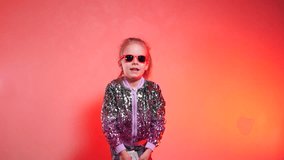 Happy girl throws up cash. Paper dollar currency dances around a delighted girl. Money rains down on a happy child, whose arms are raised in exhilaration against a bright backdrop. Slow motion shootin - Powered by Shutterstock - Get 15% off with code: PIKWIZARD15