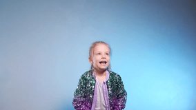 Happy girl throws up cash. Paper dollar currency dances around a delighted girl. Money rains down on a happy child, whose arms are raised in exhilaration against a bright backdrop. Slow motion shootin - Powered by Shutterstock - Get 15% off with code: PIKWIZARD15