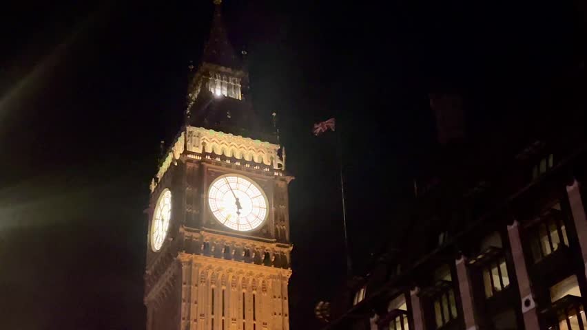 Big Ben illuminated against the night sky in London, United Kingdom, its iconic clock face glowing brightly, highlighting London