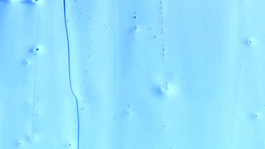 Pale blue viscous liquid flows down the screen, with bubbles and drips running