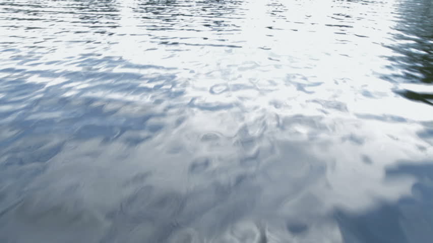 Flying over the surface of a lake, with some small rippling waves.