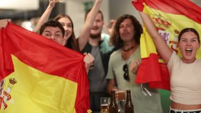 Group of friends fans watching match cheering with Spanish flag in bar - Powered by Shutterstock - Get 15% off with code: PIKWIZARD15