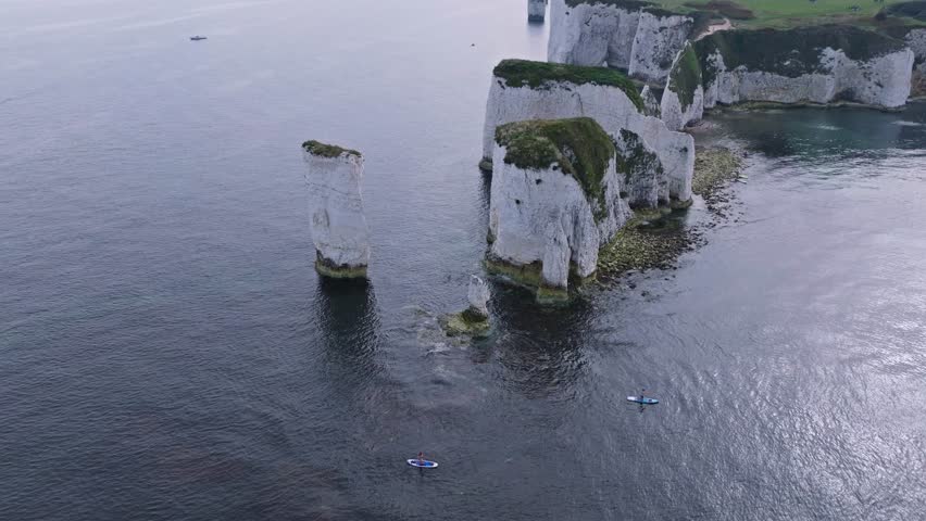 Old Harry Rocks Poole. Establishing wide aerial of large cliff faces at sunset