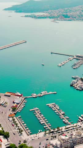 Vertical video. Kavala, Greece. Embankment and port. Historic city center. Aegean Sea. Summer, Aerial View. Rich colors