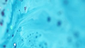 Vertical video. Acrylic liquid wave. Paint bubbles. Defocused blue color metallic foil glitter sequin particles ink fluid dye pigment mix flow motion abstract art background. - Powered by Shutterstock - Get 15% off with code: PIKWIZARD15