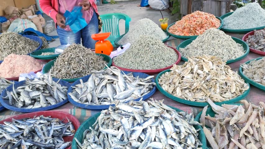 Balige, Indonesia - February, 2025 : buying and selling activity of dried seafood  