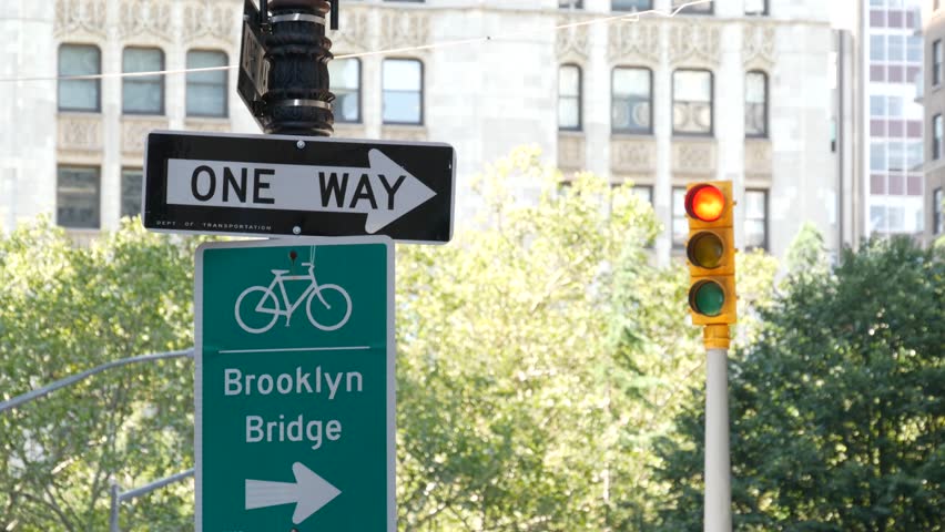 Bike lane road sign, New York. Brooklyn Bridge bicycle path, cycle route in Manhattan downtown. Cyclists way, City Hall Park. Recreational sport activity infrastructure, United States. One Way arrow.