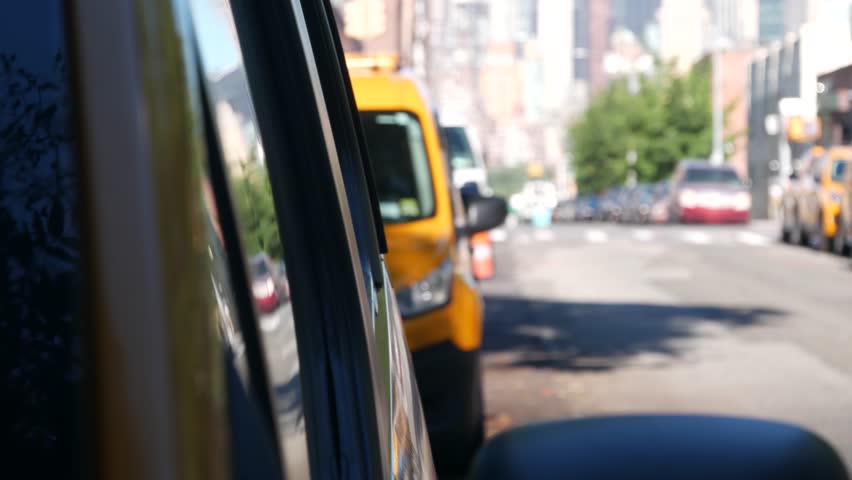 New York City. Row of yellow Taxi cars on street, Queens. Many taxi cabs on avenue, Long Island, LIC. Medallion taxicab and Manhattan Midtown urban skyline cityscape. High-rise building architecture.