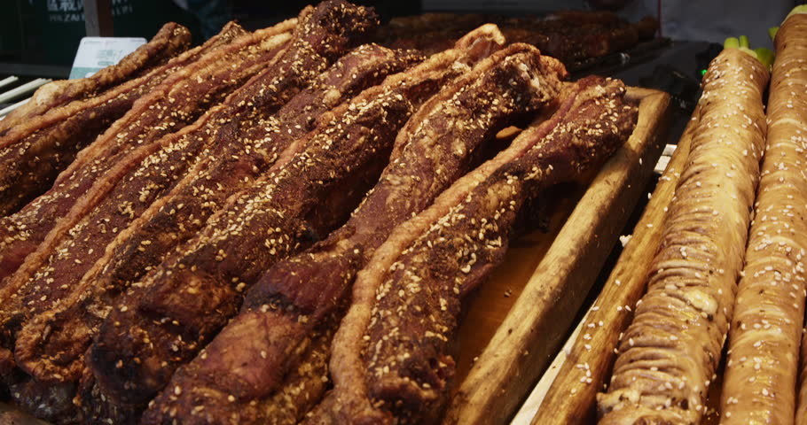 Chengdu, Sichuan, China. Smoked Pork Tenderloins. Traditional Chinese Meat Snacks. Chinese Street Food. Street Smoked Barbecue. Asian Street Food. Asian Cuisine. Gastronomic Tourism.