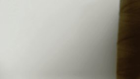 A detailed close-up of multicolored threads ranging from brown to gold, showcasing fine texture and shimmering fibers. The vibrant colors highlight the beauty of textile craftsmanship. - Powered by Shutterstock - Get 15% off with code: PIKWIZARD15